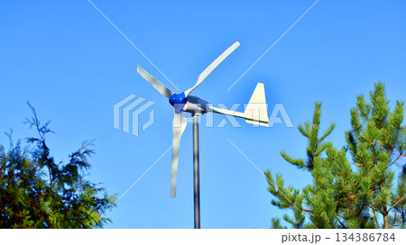 Wind turbine on blue sky. Concept of clean energy. Green technology for future.  134386784