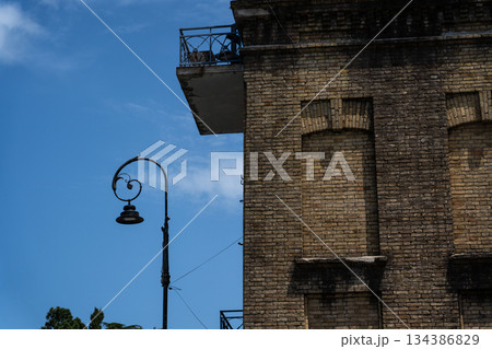 The facade of an old brick building in Batumi, Georgia. Street lamp on the left 134386829