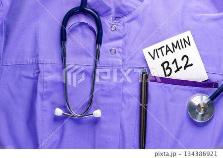 Vitamin B12 symbol. Concept words Vitamin B12 on beautiful white card. Stethoscope and pen. Beautiful medical uniform. Medical healthy lifestyle Vitamin B12 concept. 134386921