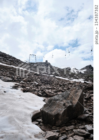 Rocky Alpine Slope With Snow Patch 134387382