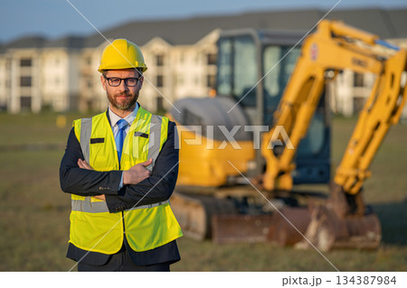 Industry worker at construction. Builder civil engineer at building. Supervisor engineer. Worker at construction site. Builder construction man. Worker supervisor heavy machinery. Safety inspection 134387984