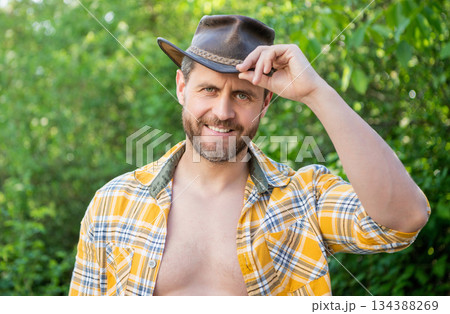 happy west man in cowboy hat. west cowboy in checkered shirt. western cowboy wearing west hat happy west man in cowboy hat. west cowboy in checkered shirt. western cowboy wearing west hat 134388269