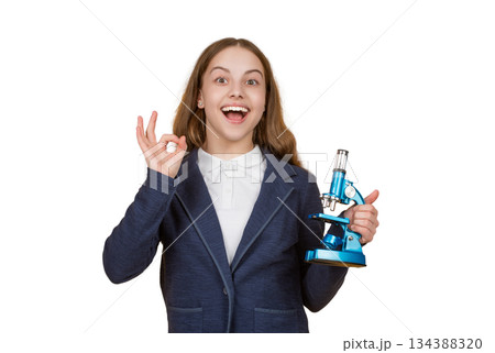 Teen girl with microscope isolated on white. Biology science for schoolgirl. Microscope research. Scientific education. School biology girl hold microscope. Student of biology. Back to school. Ok Teen girl with microscope isolated on white. Biology science for schoolgirl. Microscope research. Scientific education. School biology girl hold microscope. Student of biology. Back to school. Ok 134388320