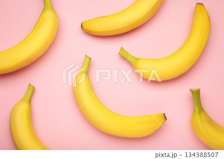 Yellow bananas flat lay on pink background. Yellow bananas flat lay on pink background. 134388507