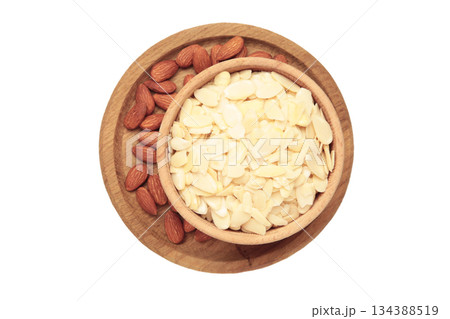 Fresh almond flakes and nuts in bowl isolated on white background Fresh almond flakes and nuts in bowl isolated on white background 134388519