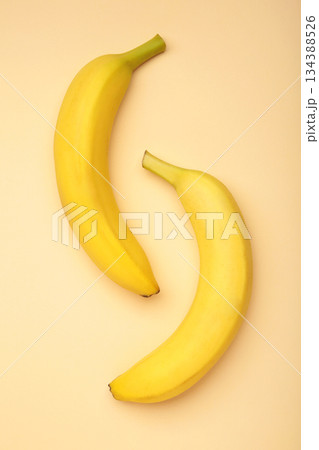 Yellow bananas flat lay on beige background. Vertical photo 134388526