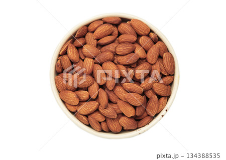 Almonds in white bowl isolated on white background Almonds in white bowl isolated on white background 134388535