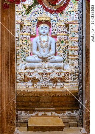 India, Interior of a Jain temple, marble statue of a Jain figure, Tirthankara, seated in meditation posture, lotus 134388682