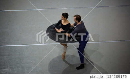 Ballet partners refining rotation technique in studio space 134389176