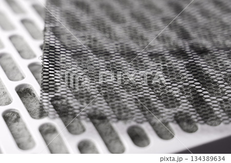 Used industrial air purifier filter parts. Perforated metal mesh and white cartridge clogged with dust Used industrial air purifier filter parts. Perforated metal mesh and white cartridge clogged with dust 134389634