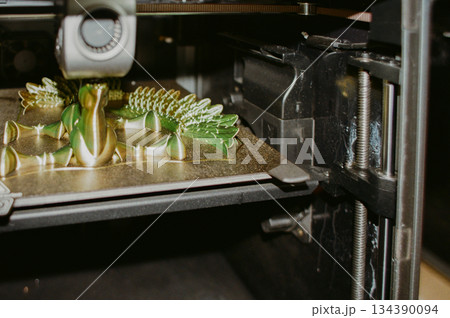 printing of three-dimensional plastic toys at factory with 3D printers. printing of three-dimensional plastic toys at factory with 3D printers. 134390094