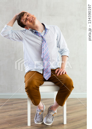 Male employee stretching at office chair at work, tired office worker 134390197