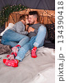 Intimate Moment With Cozy Comfort, Casual Couple Resting Together With Cheerful Socks And Charming Rustic Decor 134390418