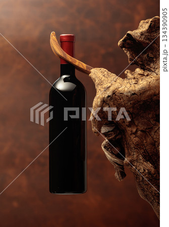 Unopened bottle of red wine and weathered snag. Unopened bottle of red wine and weathered snag. 134390905