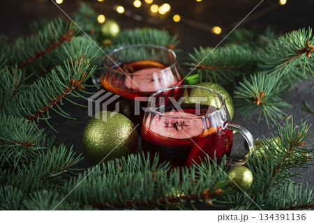 Two Glass Mugs of Mulled Wine with Christmas Decor and Fairy Lights Two Glass Mugs of Mulled Wine with Christmas Decor and Fairy Lights 134391136