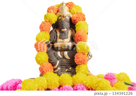 Ganesha idol decorated with colorful marigold garland for Hindu festival 134391226