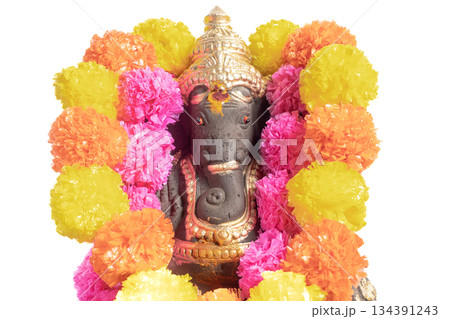 A Ganesha idol decorated with a bright floral garland for Ganesha Chaturthi. 134391243