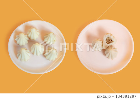 Steamed sweet modak rice dumplings on white plates. Ganesh festival 134391297