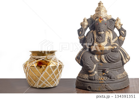 Ganesha idol with brass pot for home temple, Hindu decoration, blessings and rituals Ganesha idol with brass pot for home temple, Hindu decoration, blessings and rituals 134391351