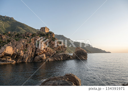 Aerial view town ruins Genoese tower of Porto Corsica France medieval watchtower Mediterranean Sea Calanches de Piana 134391971