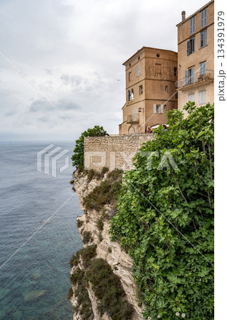 Aerial view marina cape Bonifacio south Corsica France citadel on rocky promontory on wild white limestone cliffs 134391979
