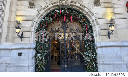 Festive holiday entrance with Christmas decorations and elegant architecture Festive holiday entrance with Christmas decorations and elegant architecture 134392898