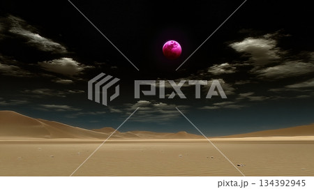 Blood Moon Rises Over a Serene Desert Landscape Under a Dark Sky 134392945