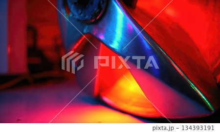 Brightly Colored Metallic Object Glowing With Intense Hues in a Dynamic Lighting Setting at Night Brightly Colored Metallic Object Glowing With Intense Hues in a Dynamic Lighting Setting at Night 134393191