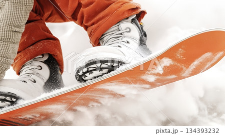Snowboarder Carving a Sharp Turn on Fresh Snow While Speeding Downhill in Bright Winter Weather Snowboarder Carving a Sharp Turn on Fresh Snow While Speeding Downhill in Bright Winter Weather 134393232