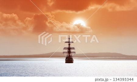 Majestic Sailing Ship Gliding Upon the Calm Sea at Dawn Against a Beautiful Orange Sky Majestic Sailing Ship Gliding Upon the Calm Sea at Dawn Against a Beautiful Orange Sky 134393344