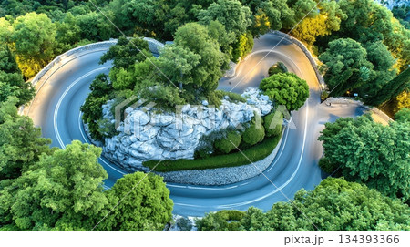Winding Asphalt Road Through Lush Mountains Offers Scenic Views and Adventurous Driving Experience Winding Asphalt Road Through Lush Mountains Offers Scenic Views and Adventurous Driving Experience 134393366