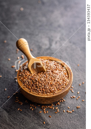 Linseed or flaxseed. Healthy flax seed in bowl on black table. 134393437