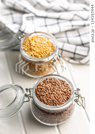Linseed or flaxseed. Healthy flax seed in jar on white table. Linseed or flaxseed. Healthy flax seed in jar on white table. 134393444