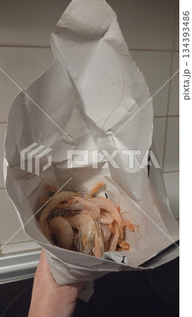 Fresh shrimps wrapped in paper for culinary delight and seafood cuisine inspiration 134393486