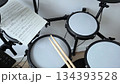 Electronic drum set with sheet music and drumsticks in music studio for practice and performance. International Music Day. Rock-n-Roll Day 134393528