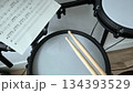 Electric drum set with sheet music and drumsticks for music practice and composition. International Music Day. Rock-n-Roll Day 134393529