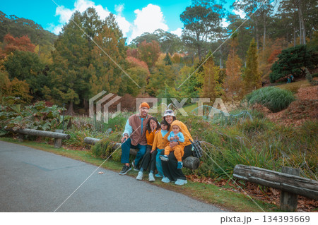 Enjoying Family Bonding Moments in the Beautiful Autumn Park Outdoors 134393669