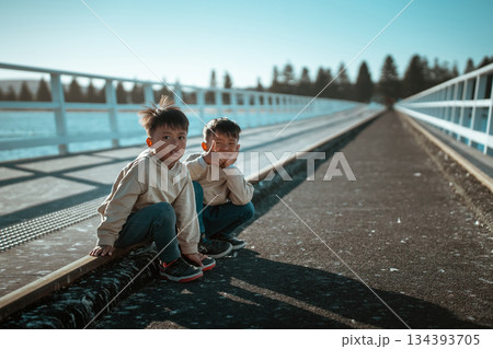 Joyful Moments Kids Happily Playing on a Beautiful Scenic Bridge, Filled with Laughter and Joy 134393705