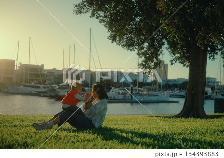 Joyful Moments Between Parent and Child at Sunset by the Marina Joyful Moments Between Parent and Child at Sunset by the Marina 134393883