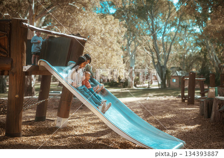 Joyful Moments at the Playground Enjoying Sliding Fun with Kids and Family Activities Joyful Moments at the Playground Enjoying Sliding Fun with Kids and Family Activities 134393887
