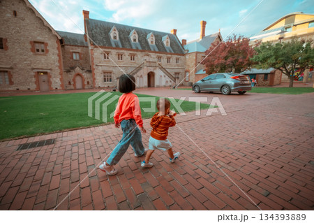 Children Joyfully Walking Around the Beautiful Historic Streets with Energy and Curiosity 134393889