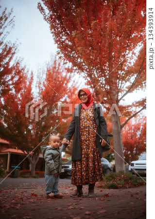 A Mother and Child Enjoying Beautiful Autumn Foliage Together 134393914