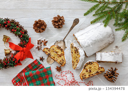Stollen with filling of raisins, candied fruit 134394478