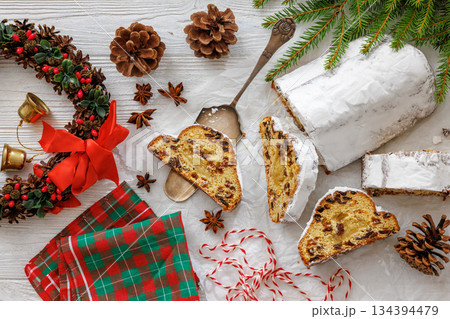 Stollen with filling of raisins, candied fruit 134394479