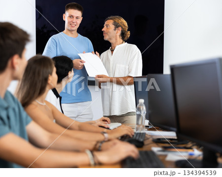 Teacher presents diploma 134394539