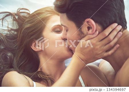 Bedroom love, kiss and face of couple relax for morning affection, calm or bonding quality time together in Canada. Smile, romantic vacation or marriage people in hotel bed for Valentines Day holiday Bedroom love, kiss and face of couple relax for morning affection, calm or bonding quality time together in Canada. Smile, romantic vacation or marriage people in hotel bed for Valentines Day holiday 134394697