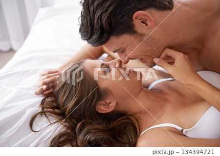Bed love, face and laughing couple relax for morning peace, valentines day or quality time together. Eye contact, romantic vacation and profile people bond in hotel bedroom for Toronto Canada holiday Bed love, face and laughing couple relax for morning peace, valentines day or quality time together. Eye contact, romantic vacation and profile people bond in hotel bedroom for Toronto Canada holiday 134394721