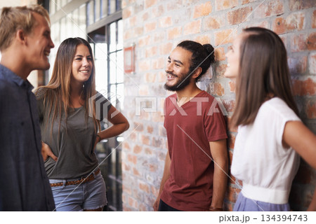 Happy, friends and students talking together in a hallway for discussion, learning or a chat. Diversity group of women and men at campus or university to talk about education, project or school work Happy, friends and students talking together in a hallway for discussion, learning or a chat. Diversity group of women and men at campus or university to talk about education, project or school work 134394743