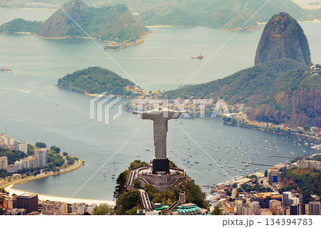 Brazil landscape, city and Christ the Redeemer on hill for tourism, sightseeing and travel destination. Traveling, Rio de Janeiro and aerial view of statue, sculpture and global landmark on mountain 134394783