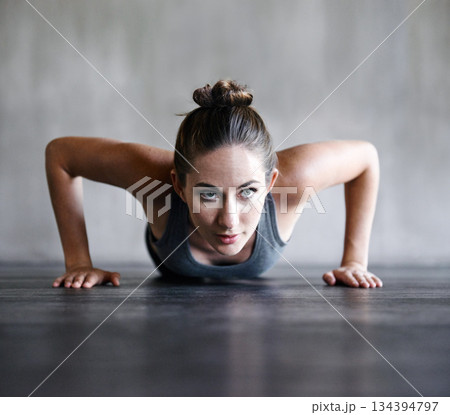 Pushup, fitness and woman on a floor for training, cardio and endurance at gym. Push up, exercise and female athlete at a health center for core, strength and ground workout with determined mindset 134394797